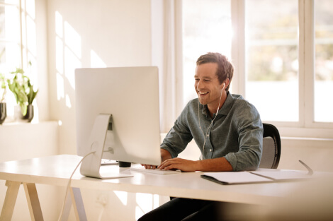 Image of a man typing on a computer