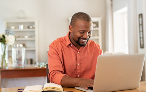 Image of a man typing on a laptop